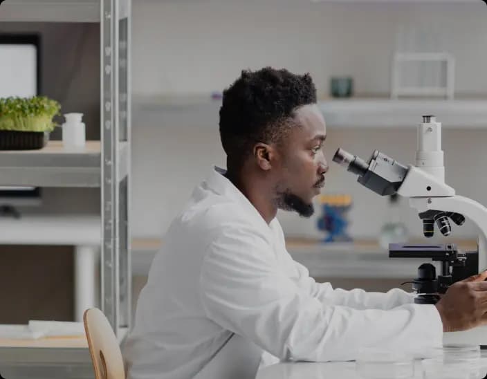 Scientist looking into microscope
